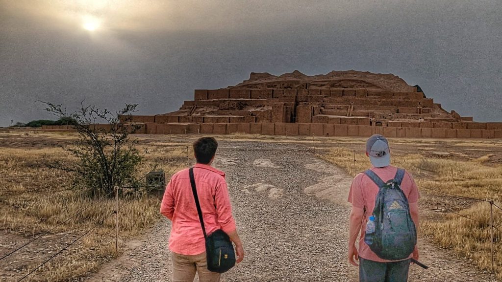 Two tourists viewing the ancient Chogha Zanbil Ziggurat in Susa, a major highlight of our Iran tour package